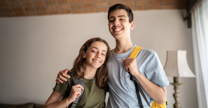 Portrait of a teenager siblings with backpack at home