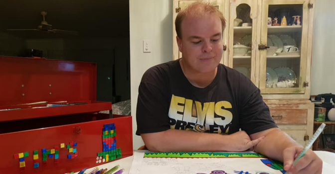 Tim sharp, drawing a colourful drawing inside a home.