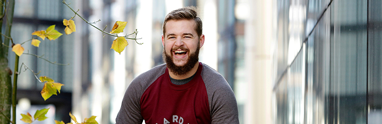 Man sitting outside laughing happily