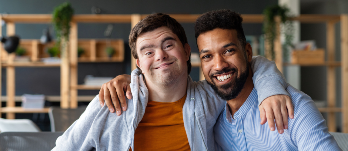 person with disability embracing his carer