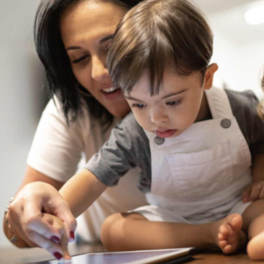 A mother and young child looking at a tablet together